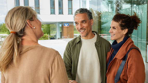 Brakle startbild  Happy real estate agent shaking hands with potential new home buyers.