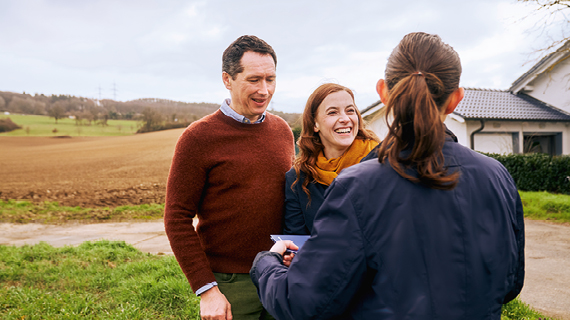 Brakle startbild  Happy real estate agent shaking hands with potential new home buyers.